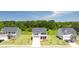 Exterior view of a new neighborhood showcasing several two-story homes with spacious front lawns at 300 Halibut Circle Cir, Covington, GA 30016