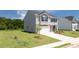 View of a new gray two-story home on a grassy lot with a brick-accented facade at 300 Halibut Circle Cir, Covington, GA 30016