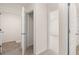 Hallway with neutral carpet, white walls and multiple open doorways at 300 Halibut Circle Cir, Covington, GA 30016