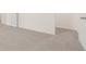 Spacious carpeted hallway with white walls and trim and multiple doorways at 300 Halibut Circle Cir, Covington, GA 30016