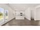 Open kitchen with white cabinets, island with granite countertops, and stainless steel appliances adjacent to dining area at 300 Halibut Circle Cir, Covington, GA 30016