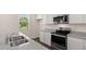 Bright kitchen featuring stainless steel appliances, granite countertops, and a large window at 300 Halibut Circle Cir, Covington, GA 30016
