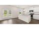 Bright kitchen features white cabinets, granite countertops, stainless steel appliances and an island with a sink at 300 Halibut Circle Cir, Covington, GA 30016