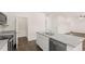 Open kitchen with stainless steel appliances, an island with a sink, and hardwood floors at 300 Halibut Circle Cir, Covington, GA 30016