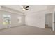 Bright main bedroom offers plush carpet, ample natural light and a trey ceiling with ceiling fan at 300 Halibut Circle Cir, Covington, GA 30016