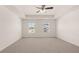 Spacious carpeted main bedroom features a trey ceiling with ceiling fan and natural light at 300 Halibut Circle Cir, Covington, GA 30016