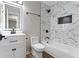 Modern bathroom with stylish vanity, illuminated mirror, and tiled shower and tub at 6058 Ledgewood Dr, Forest Park, GA 30297