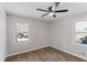 Bright bedroom features modern ceiling fan, wood-look flooring, and double windows at 6058 Ledgewood Dr, Forest Park, GA 30297