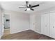 This bedroom features hardwood-style floors, a ceiling fan, and easy access to the bathroom at 6058 Ledgewood Dr, Forest Park, GA 30297
