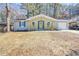 Charming ranch home with yellow porch railing, light gray brick, and cheerful yellow front door at 6058 Ledgewood Dr, Forest Park, GA 30297