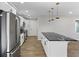 Modern kitchen featuring stainless steel appliances, white cabinets, and a black countertop island at 6058 Ledgewood Dr, Forest Park, GA 30297