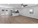 Open concept living room and kitchen with hardwood floors and stainless steel appliances at 6058 Ledgewood Dr, Forest Park, GA 30297