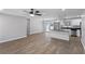 Bright, open-concept living room and kitchen with modern lighting, stainless steel appliances and hardwood floors at 6058 Ledgewood Dr, Forest Park, GA 30297