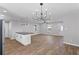 Open concept living area with modern chandelier and hardwood-style floors at 6058 Ledgewood Dr, Forest Park, GA 30297