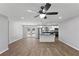 Bright, open-concept living room and kitchen with modern lighting, stainless steel appliances and hardwood floors at 6058 Ledgewood Dr, Forest Park, GA 30297