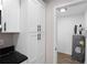 Spacious pantry featuring white cabinets and black countertop at 6058 Ledgewood Dr, Forest Park, GA 30297