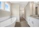 Bright bathroom featuring a large soaking tub and white cabinets with granite countertops at 1977 American Way # 30, Kennesaw, GA 30144