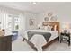 Bedroom with a wooden headboard, natural decor, and a blue arm chair at 1977 American Way # 30, Kennesaw, GA 30144