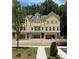Charming yellow townhomes, each featuring attached garages and inviting curb appeal at 1977 American Way # 30, Kennesaw, GA 30144