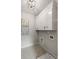 Laundry room with white cabinets, modern light fixture, and hexagon tile flooring at 1977 American Way # 30, Kennesaw, GA 30144