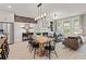 Open-concept living area with fireplace, dining space, and large windows at 1977 American Way # 30, Kennesaw, GA 30144