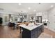 Open-concept living space with a modern kitchen island, dining area, and living room at 1977 American Way # 30, Kennesaw, GA 30144
