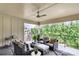 Covered patio with comfortable seating, ceiling fan, and views of trees at 1977 American Way # 30, Kennesaw, GA 30144