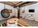 Bedroom featuring a modern egg chair, exposed brick, and colorful rug at 170 Boulevard Se # 131H, Atlanta, GA 30312