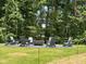 An outdoor fire pit surrounded by comfortable seating in a wooded area at 1983 American Way # 27, Kennesaw, GA 30144
