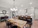 Kitchen and dining area with stainless steel appliances and pendant lighting above the island at 1983 American Way # 27, Kennesaw, GA 30144