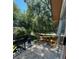 Private balcony with a table and chairs provides a cozy outdoor seating area with tree views at 1181 Church St # G, Decatur, GA 30030