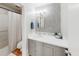 This bathroom features a vanity with storage, a decorative mirror, and a shower with white curtain at 1181 Church St # G, Decatur, GA 30030
