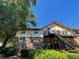 Brick exterior elevation with black staircases and second story patio under a beautiful blue sky at 1181 Church St # G, Decatur, GA 30030