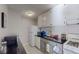 Efficient kitchen featuring white cabinets, subway tile backsplash, and modern appliances at 1181 Church St # G, Decatur, GA 30030