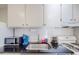 Bright kitchen featuring white cabinets and granite countertops with a functional design at 1181 Church St # G, Decatur, GA 30030