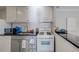 Functional kitchen featuring white cabinets and a peninsula counter with an open view at 1181 Church St # G, Decatur, GA 30030