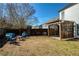 Large, grassy backyard with a wooden fence, pergola, and comfortable outdoor furniture at 301 Ridgewood Trl, Canton, GA 30115