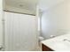 Well-lit bathroom featuring a shower with curtain, white vanity, and toilet at 301 Ridgewood Trl, Canton, GA 30115