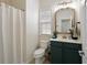 Stylish bathroom featuring a vanity with green cabinets, modern fixtures and a shower curtain at 301 Ridgewood Trl, Canton, GA 30115