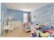 bedroom with custom blue painted walls and two single beds with decorative comforters at 301 Ridgewood Trl, Canton, GA 30115