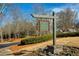 Community sign for The Harmony Lake Club surrounded by lush landscaping and trees at 301 Ridgewood Trl, Canton, GA 30115