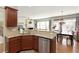 Open concept kitchen with granite countertops and stainless steel appliances overlooking a dining area at 301 Ridgewood Trl, Canton, GA 30115