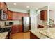 Well-equipped kitchen featuring granite countertops, stainless steel appliances, and hardwood floors at 301 Ridgewood Trl, Canton, GA 30115