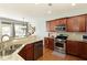 Cozy kitchen featuring granite countertops, stainless steel appliances, and wooden cabinets at 301 Ridgewood Trl, Canton, GA 30115