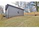 Side and rear exterior view of the house with a large backyard and wooden fence at 3085 Jackson St, Hapeville, GA 30354