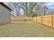 Backyard with grass and newly installed wooden privacy fence at 3085 Jackson St, Hapeville, GA 30354