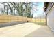 View of the backyard and detached garage with extended driveway and a wood fence at 3085 Jackson St, Hapeville, GA 30354