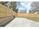 Backyard view with new wooden fence and concrete retention wall at 3085 Jackson St, Hapeville, GA 30354