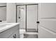 Modern bathroom featuring tiled shower with glass enclosure, sleek vanity, and stylish fixtures at 3085 Jackson St, Hapeville, GA 30354