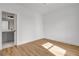 Cozy bedroom featuring hardwood floors and an ensuite bathroom with gray vanity at 3085 Jackson St, Hapeville, GA 30354